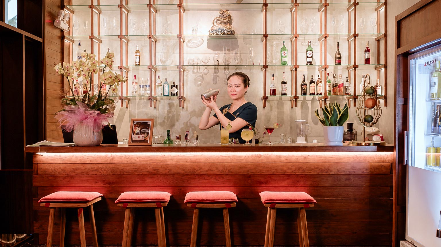 A bartender preparing a drink at Little Gem Hoi An